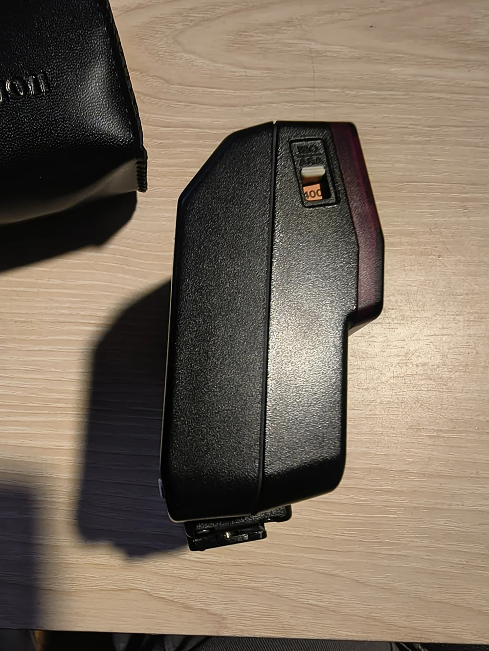 vintage Canon Speedlite 244T electronic flash unit with its leather case,